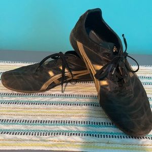 Brown leather Asics with gold accent